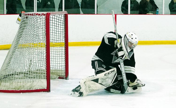 Ryder Moser stops the puck with a great stick save in the win over Fargo. Photo by Larry Stokke.