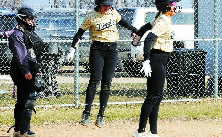 Remi Larson and Hannah Russell celebrate scoring a home run against the Cards. Photo by Larry Stokke.