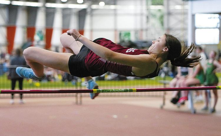 Taya Feist clears the high jump with room to spare at the Green Wave Meet on April 19. Photo by Larry Stokke.