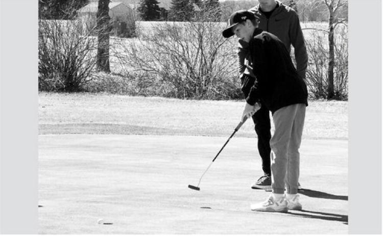 Dyson Askvig sinks a putt at Creel Bay April 29. Photo by Larry Stokke.