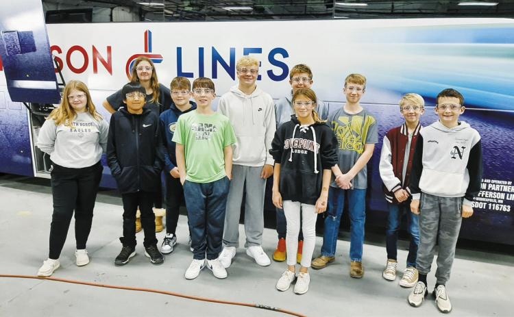 North Border Pembina students pose in front of a bus being built at the Motorcoach Industries plant in Pembina.