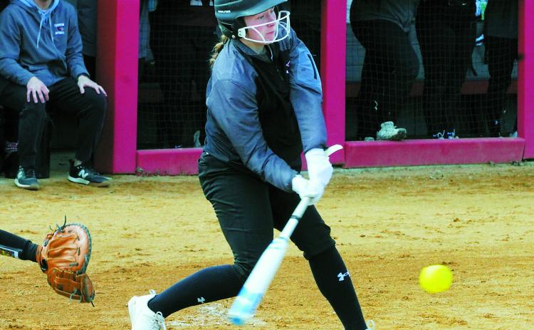 Meredith Romfo connects for a base hit against the Carrington Cardinals on April 22. Photo by Larry Stokke.
