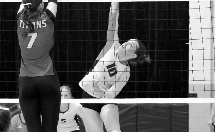 Ava Kemnitz leaps and adds a point for the Tornadoes. Photo by Larry Stokke.