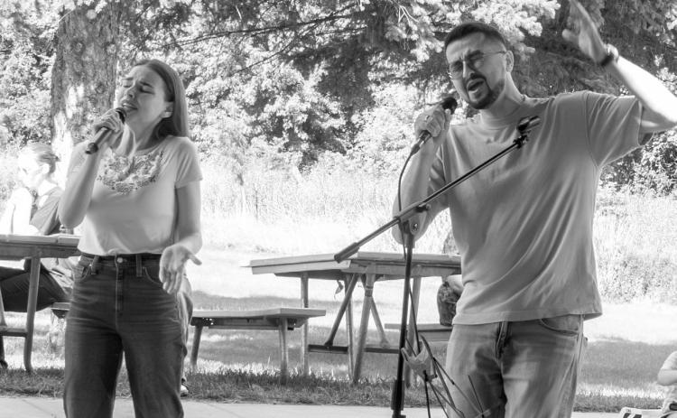 Dmytro Somkin, right, and Kseniia Somkina entertain the crowd with a Ukrainian song during the FM Volunteers for Ukraine International Day of Peace fundraiser in Moorhead, Minnesota, on Sept. 21, 2025. (Photo by W. Scott Olsen/For the North Dakota Monitor)