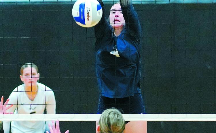 Jaelyn Johnson with a stuff block in their five set game in Crystal on Oct. 13. Photo by Larry Stokke.