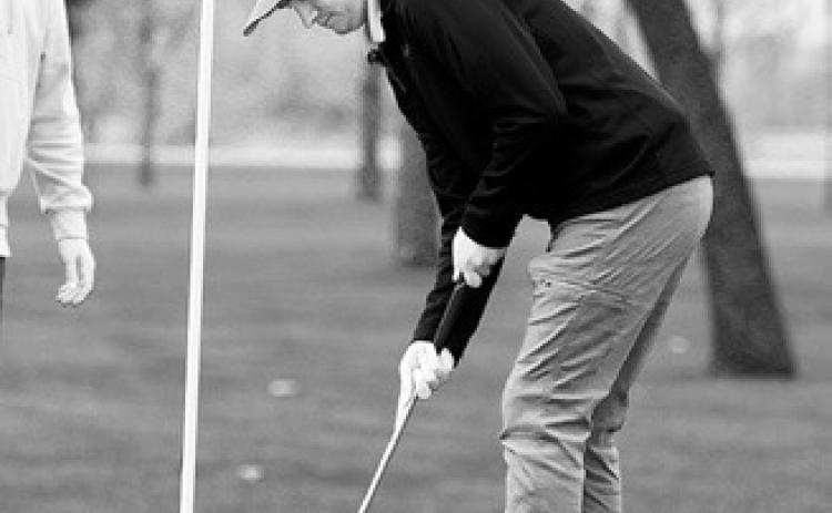 Tyler Kram sinks a putt at the Larimore Golf Meet and finished with a score of 95. Photo by Larry Stokke.