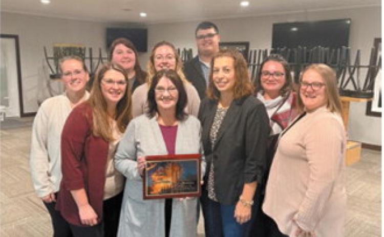 FM Bank employees gather around Carol Mikkelsen, center, following her recognition as Employee of the Year at the Langdon Area Chamber of Commerce's annual banquet Oct. 15. Mikkelsen was honored for her 40 years of service at FM Bank and her dedication to the Langdon community. Photo courtesy of Langdon Area Chamber of Commerce.