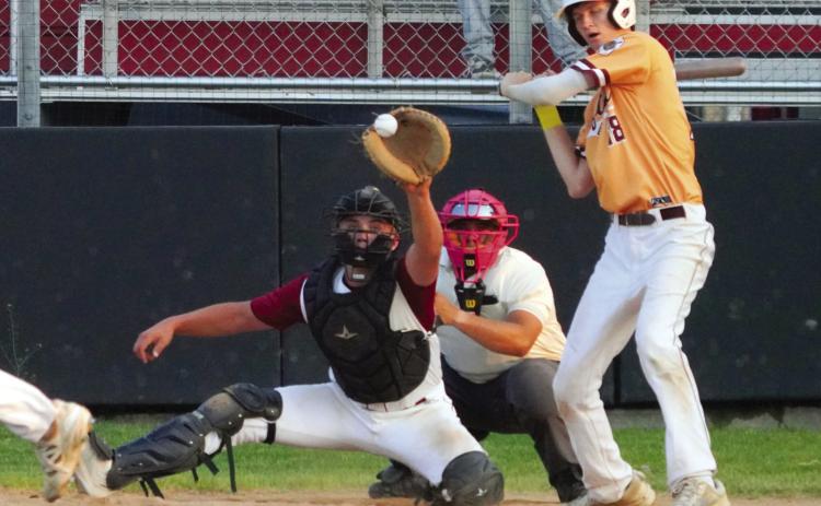 Landon Schneider eyes the ball with a catch behind the plate against Grafton in Langdon. PHOTO BY LARRY STOKE.
