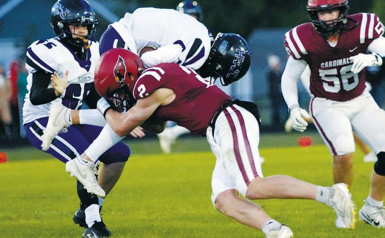 Jax Johnson tackles a Hornet ball carrier, taking him off his feet. Photo by Larry Stokke.