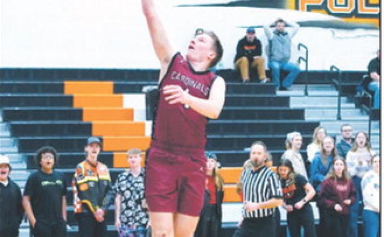 Levi Swanson drives in on a fast break and drops in one of his 9 points in the Cards win over Larimore on Jan 3. Photo by Larry Stokke.