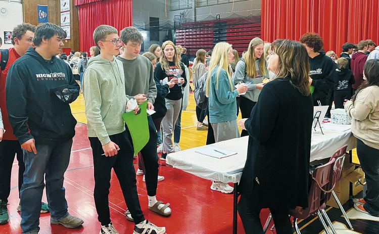 Students gather around to discuss the job fair with Kari Phillips and Jessica Tull. Photo by Shannon Duerr.