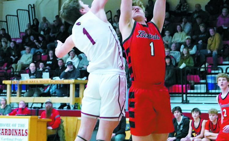 Eastyn Schaefer blocks a shot by the Bearcat's Alec Peyerl. Photo by Larry Stokke.