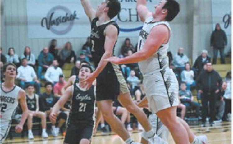 Guard Kaden Moore gets a quick release on a layup just ahead of the Chargers’ defense. Photo by Ashley Schafer
