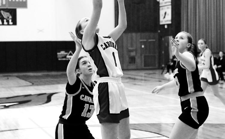 Ary Schaefer lays in a basket to add to her 18-point night in the Cardinals' win over Cavalier. Photo by Larry Stokke.