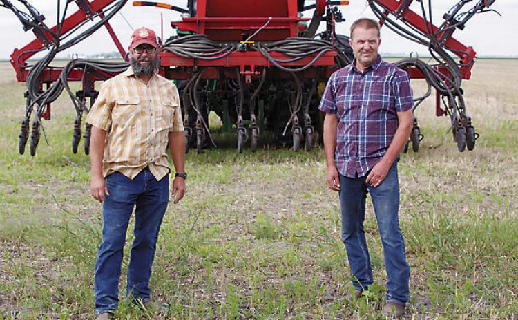 Chris Walberg (left) and Tyler Zimmerman, lifelong friends who have turned to regenerative agriculture together, were featured in a mini-documentary that’s been viewed nearly 600,000 times in the past six months. Photo provided by Kiss the Ground.