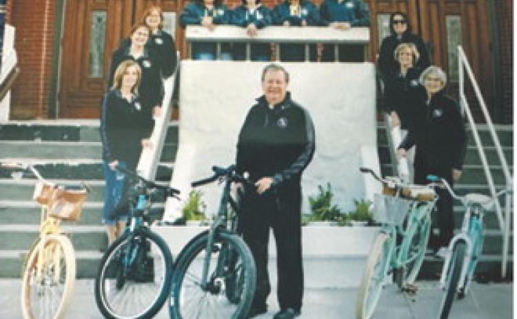 Father Phil Ackerman poses with members of the Padre Pedal Pushers outside St. Alphonsus Catholic Church in Langdon. Ackerman started the cycling group during his time as pastor, and the friendships formed through the rides remain among his favorite memories of his years in the community. Submitted photo