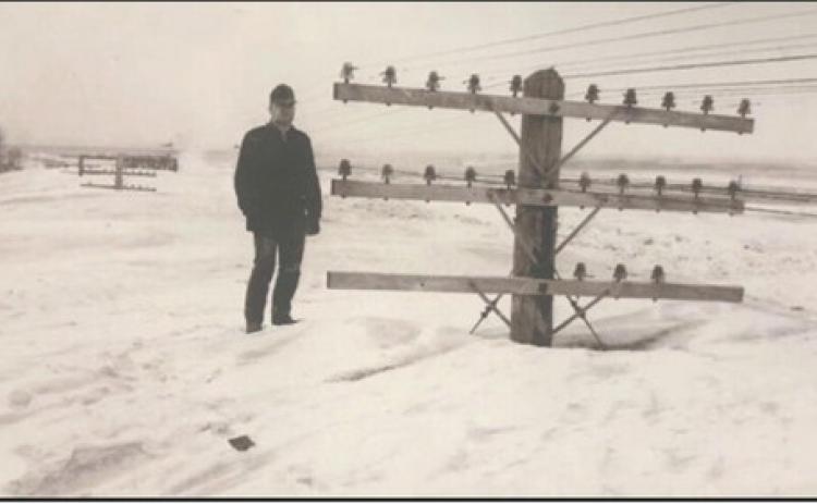 A picture is worth a thousand words: This iconic 1966 blizzard photo was taken near Linton, in south-central North Dakota. Pictured is Bill Koch, North Dakota DOT employee, standing next to a set of railroad telegraph poles. It was taken by fellow ND DOT employee Ernest Feland on March 9, 1966. Photo courtesy North Dakota State Historical Society/NOAA/NWS archives
